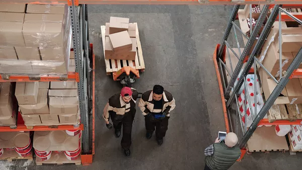 Two workers in a factory setting.
