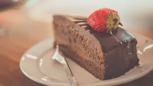 Chocolate cake with strawberry on top.