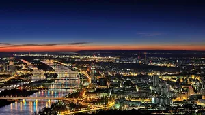 An aerial view of the Danube through Vienna at dusk.