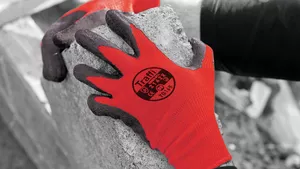 A man wearing a pair of red safety gloves.