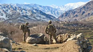 Two soliders in Afghanistan framed by the beautiful landscape.