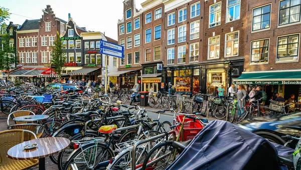 Hundreds of bikes in one of Amsterdam&apos;s bustling streets.