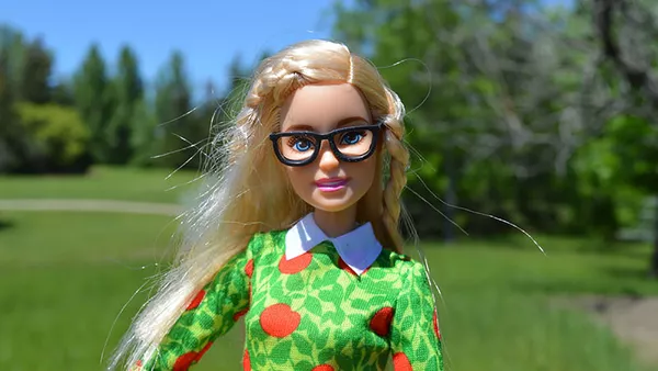A barbie doll in glasses.