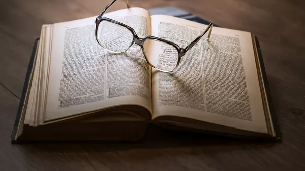 A pair of glasses on top of a book..