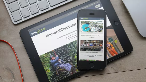 ANS Global: Company Website Living Wall Applications page on an Apple iPhone which is sat on top of an iPad.