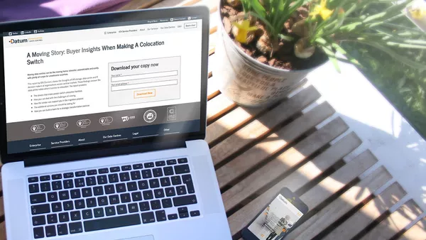 An example of a custom landing page shown on an Apple MacBook outside on a bench next to a flower pot.